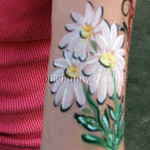 Facepaint of flowers on an arm